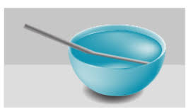 A bowl with a spoon in it

Description automatically generated
