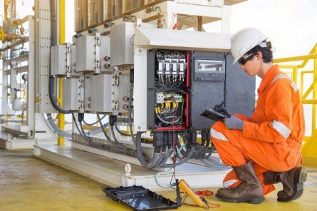 A person in orange jumpsuit and white hard hat

Description automatically generated