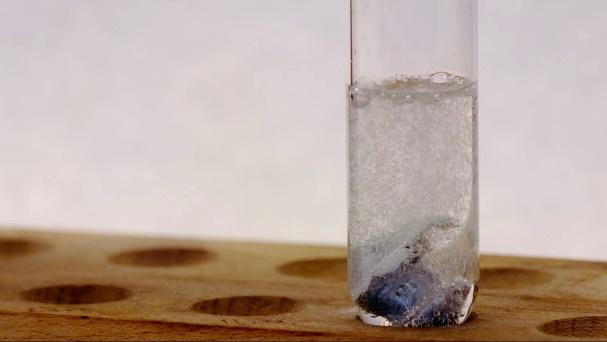 A glass tube with a substance in it

Description automatically generated